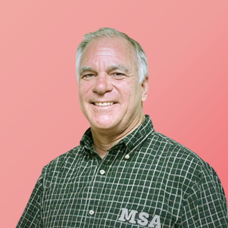 Rick Kuemin smiling in a green plaid MSA shirt