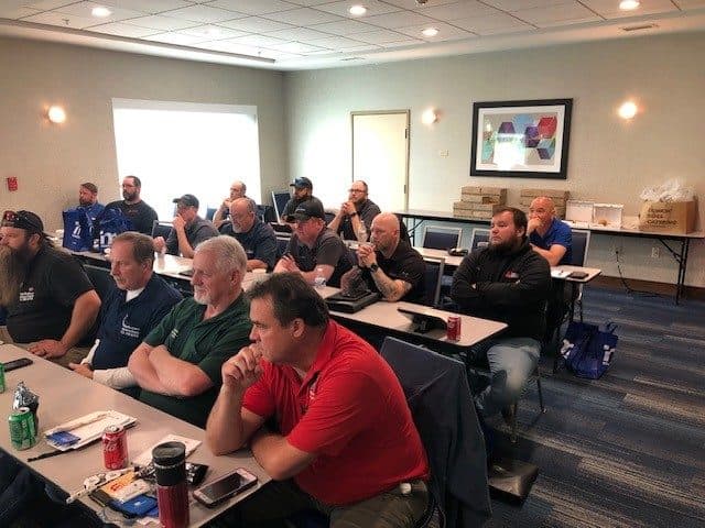 Members attending a seminar in a hotel meeting room